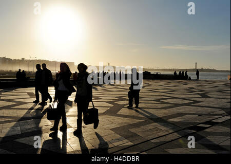 People enjoying the sunset in the spacious forecourt of the Hassan II mosque Stock Photo
