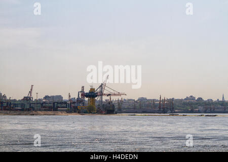 Cargo crane, ship and grain dryer in port Odessa, Ukraine Stock Photo