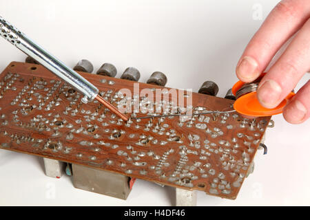 soldering iron in his hand on a white background Stock Photo