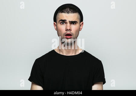 Portrait of young emotional man in hat Stock Photo