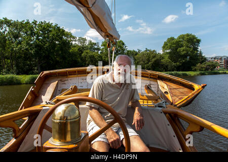 Older man on his sailing ship Stock Photo