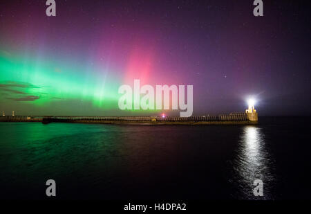 Aurora Borealis, Northern Lights display at Blyth pier and lighthouse over Blyth harbour, Northumberland, night sky Stock Photo