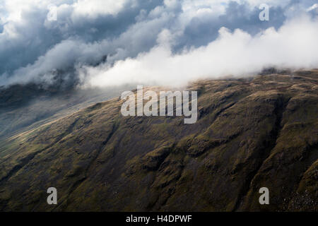 Clouds drifting over mountain tops in the English Lake District, above Wrynose Pass Stock Photo
