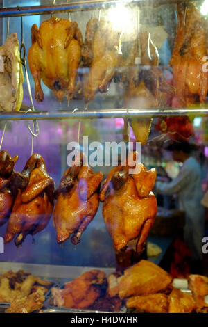 Cantonese style roasted ducks,chickens and pork hanging inside the window of a Chinese restaurant in Chinatown.Manhattan.New York,USA Stock Photo