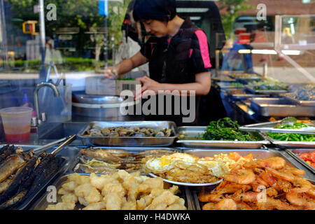 Food display inside of the window of a Chinese buffet restaurant in East Broadway,Chinatown,Manhattan,New York,USA Stock Photo