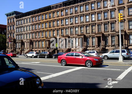 Renovated historic brownstone apartment building on Lenox Avenue aka Malcolm X Boulevard.Harlem.Manhattan,New York City,USA Stock Photo