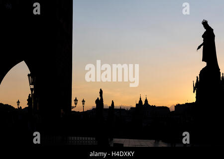 Sunset from the end of the Charles Bridge (Karlūv Most). King Charles IV statue in the foreground. Prague, Czech Republic. Stock Photo