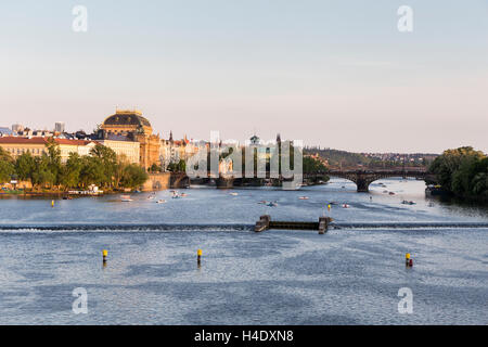 View from Charles Bridge over the Vltava River including weir and Legii (Legionaru) bridge with the National Theatre on left. bu Stock Photo