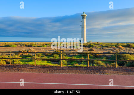 Walking alley and bike lane with view of Lighthouse on Morro Jable beach on Jandia peninsula, Fuerteventura, Canary Islands, Spain Stock Photo