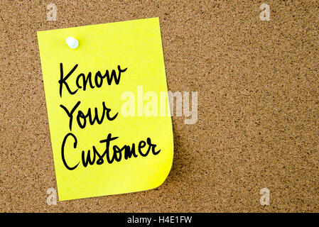 Know Your Customer text written on yellow paper note pinned on cork board with white thumbtack. Business concept image Stock Photo