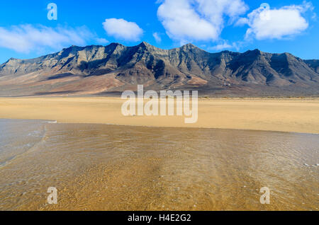 Ocean water on sand at beautiful Cofete beach, Fuerteventura, Canary Islands, Spain Stock Photo