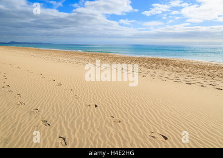 Footprints in sand on and beautiful turquoise sea on Jandia beach, Morro Jable, Fuerteventura, Canary Islands, Spain Stock Photo