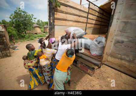 Bags of shea nuts are loaded on to a lorry going to a shea butter fair trade production centre in Burkina Faso, West Africa. Stock Photo