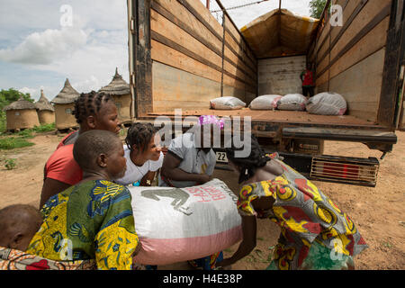 Bags of shea nuts are loaded on to a lorry going to a shea butter fair trade production centre in Burkina Faso, West Africa. Stock Photo