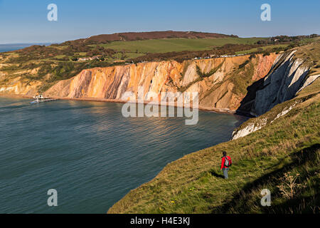 Hiker at cliff edge, Alum Bay, Isle of Wight, UK Stock Photo