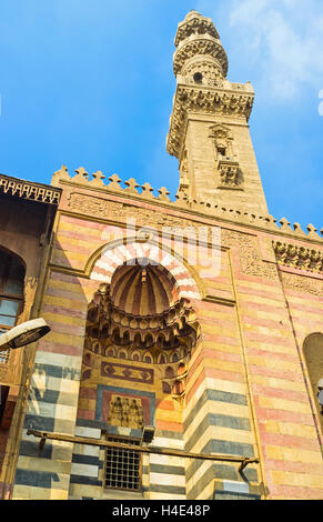 The iwan and minaret of Sultan Al-Ashraf Barsbay Mosque are richly decorated with colorful stone tiles, Cairo Egypt Stock Photo