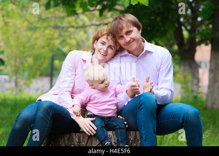 Happy young family spending time together outside Stock Photo
