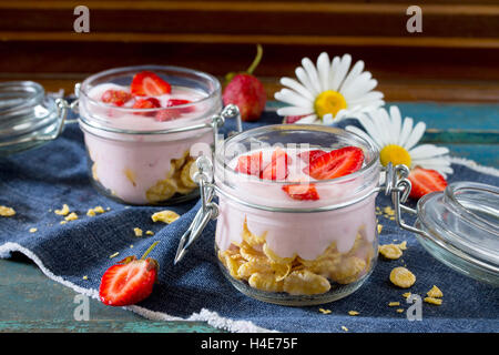 Homemade yogurt with corn flakes and berries, healthy eating yogurt in the rustic style. Stock Photo