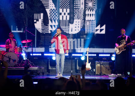 Seattle-based musician Sol performs for the crowd at WE Day Seattle in Key Arena Stock Photo