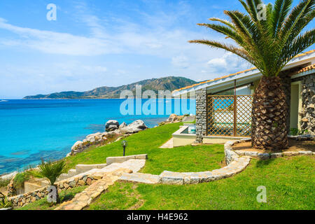 Beautiful holiday villa house on coast of Sardinia island - view from promenade at Campolungo beach, Italy Stock Photo