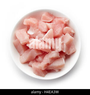 Raw cut meat chunks in white bowl isolated on white background, top view Stock Photo