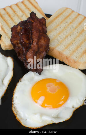 Fried eggs with toast and bacon Stock Photo