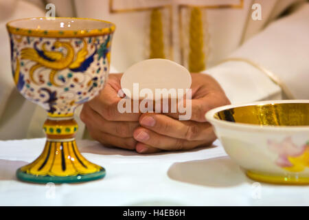 bread becomes the body of Christ in the hands of the pope, holy father Stock Photo