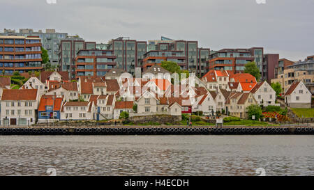 Old Stavanger, with  traditional white painted wooden houses and modern appartment buildings in the background. view from across Stock Photo