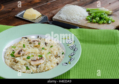 Italien risotto with mushrooms and spring onion Stock Photo