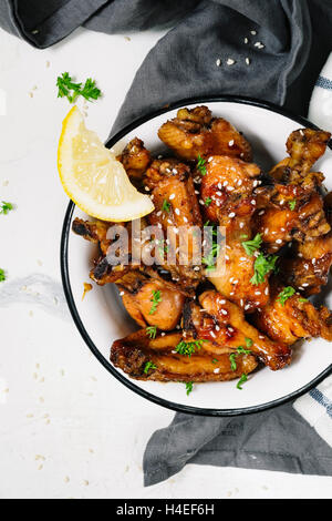 Chicken wings with sesame seeds in sweet and sour sauce Stock Photo