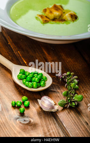 Young pea soup with small garlic croutons Stock Photo