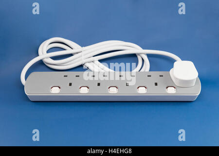 UK extension lead on a blue background Stock Photo