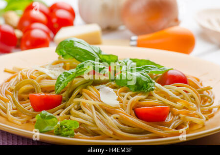 Lemon pasta with cherry tomatoes, basil and nuts, 2 plates, various serving Stock Photo