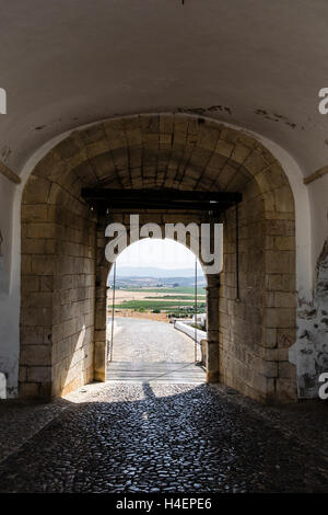A view looking out the town gate from inside the medieval town of Estremoz, Portugal. Stock Photo