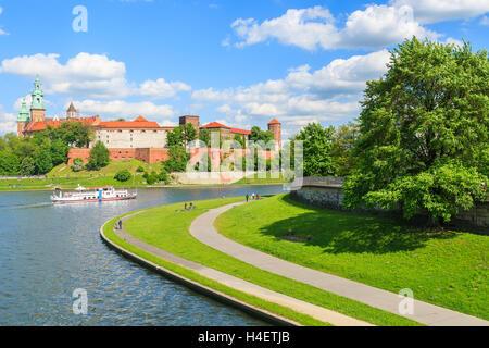 Tourist boat on VIstula river with Wawel Royal Castle in the background, Poland Stock Photo