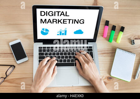 Digital marketing website on a laptop computer with female hands typing on keyboard Stock Photo