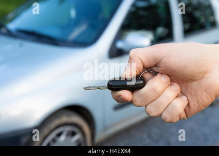 Car keys in hand to unlock Stock Photo
