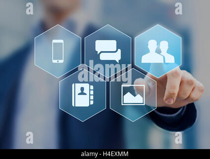 Social network icons on virtual screen buttons with a person in background Stock Photo