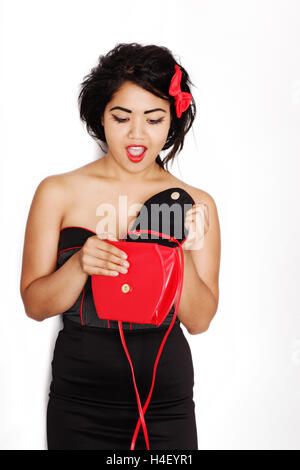 Woman looking into her handbag, surprised Stock Photo