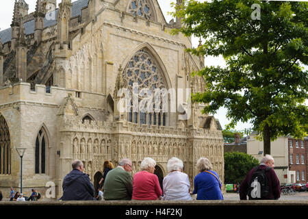 Exeter, Devon, England, UK - 30 September 2016: A group of unidentified people look at Exeter Cathedral. Stock Photo