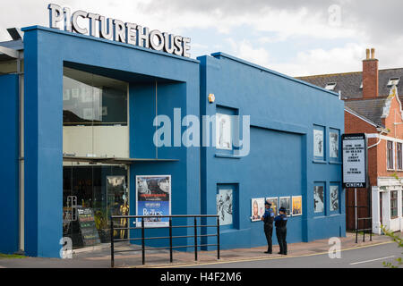 Exeter, Devon, England, UK - 30 September 2016: Unidentified policemen look at what films are on at Exeter Picturehouse. Stock Photo