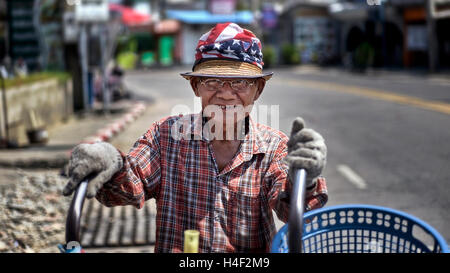Elderly Thailand man road sweeper happy and smiling for the camera. Thailand S. E. Asia Stock Photo