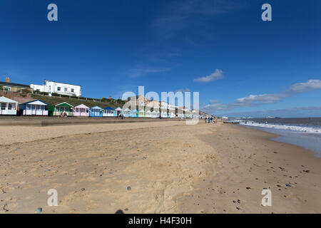 Town of Southwold, England. Southwold beach with brightly painted beach huts on North Parade, in the background. Stock Photo
