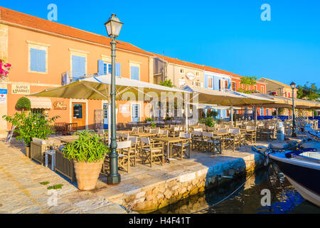 FISKARDO PORT, KEFALONIA ISLAND, GREECE - SEP 18, 2014: traditional greek houses in port of Fiskardo village. This town is most visited tourist attraction on the island. Stock Photo