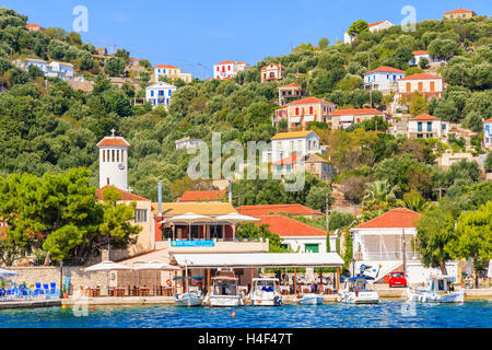 KIONI PORT, ITHAKA ISLAND, GREECE - SEP 19, 2014: traditional greek houses in port of Fiskardo village. This town is most visited tourist attraction on the island. Stock Photo