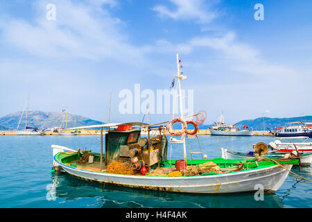 SAMI PORT, KEFALONIA ISLAND, GREECE - SEP 20, 2014: traditional Greek fishing boat in port of Sami village. Colorful boats are symbol of Greek islands. Stock Photo