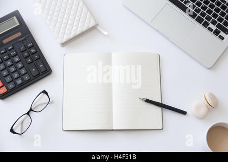 Top view of a working desk with open notebook Stock Photo