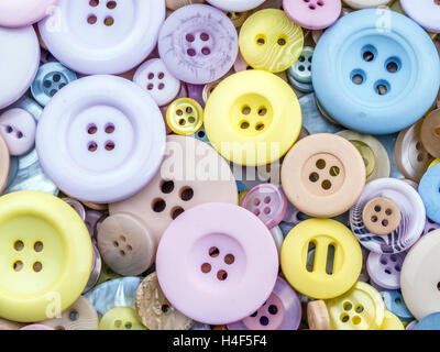 Pile of apparel buttons in different size and colors shot from above Stock Photo