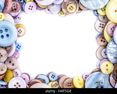 Framework arranged from apparel buttons in different size and colors with white copy space Stock Photo