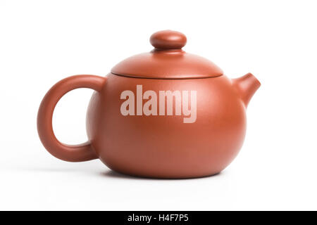 Brown small earthenware teapot with closed lid isolated on white background Stock Photo
